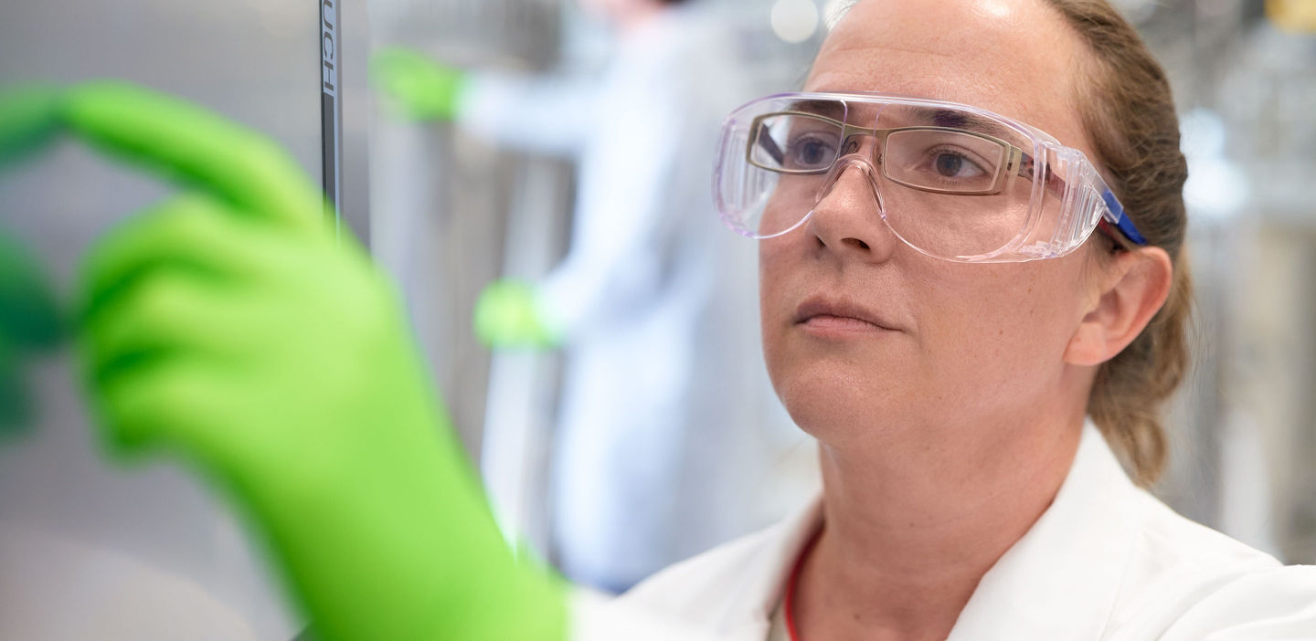 Lab technician touching a screen