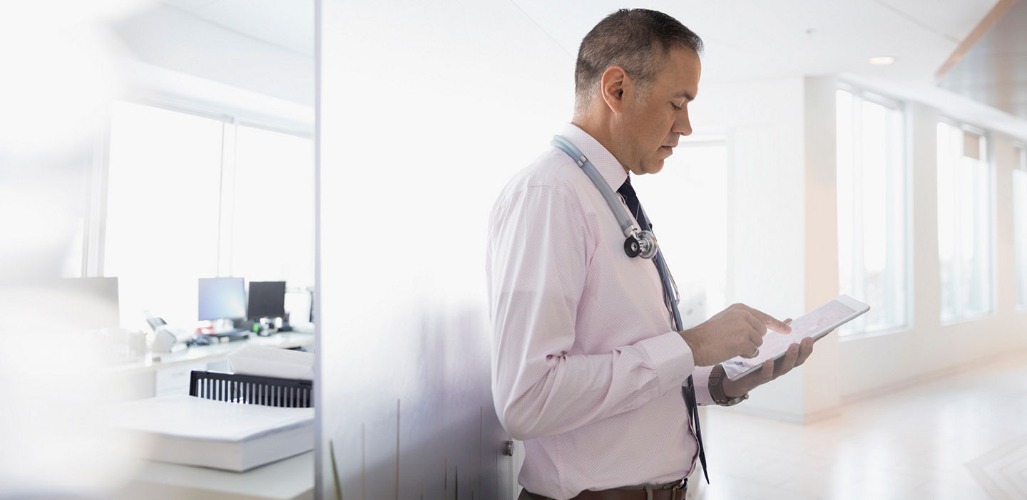 doctor doing research on his tablet