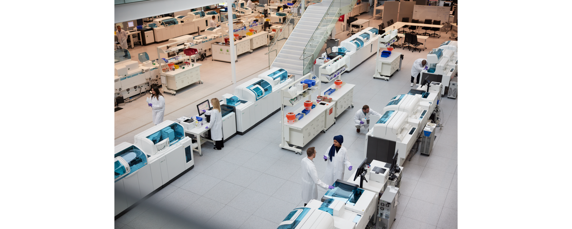 Lab staff operating Roche 360 automated systems, supported by Roche Diagnostics Customer Service. 