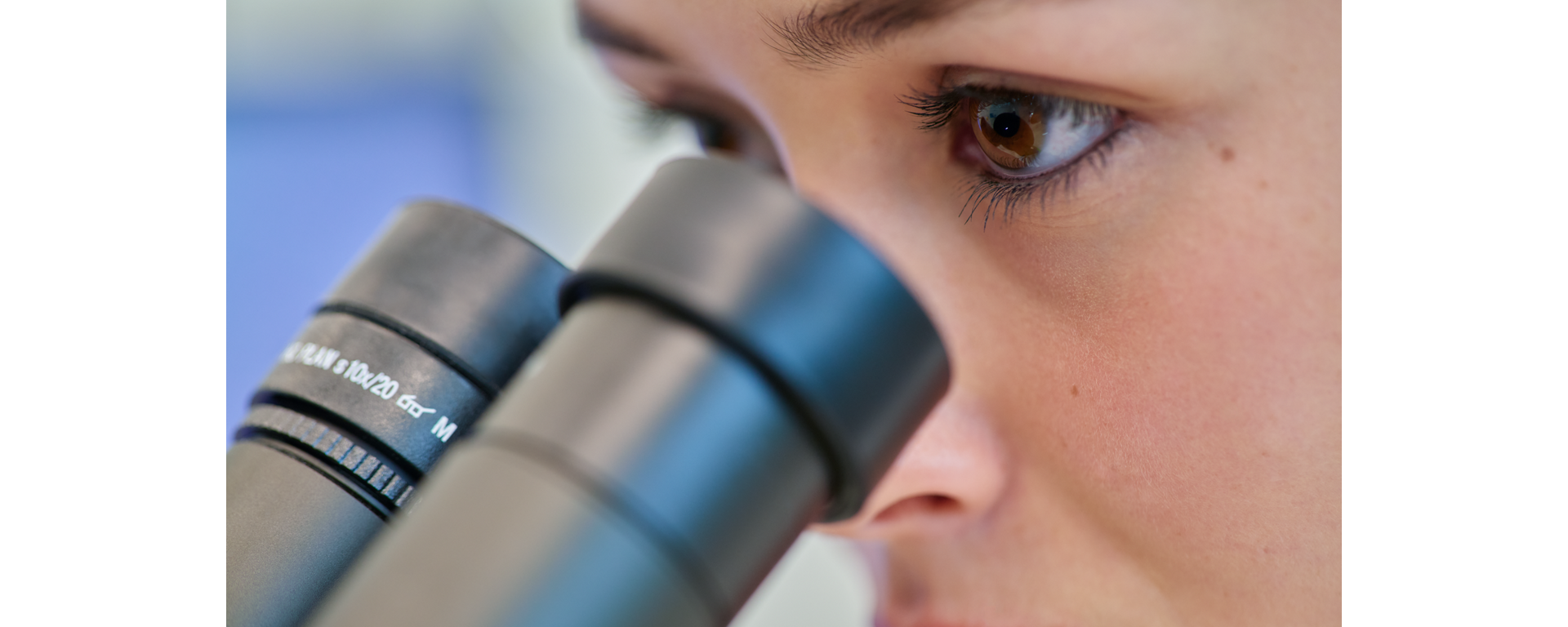 Scientist looking through a scope