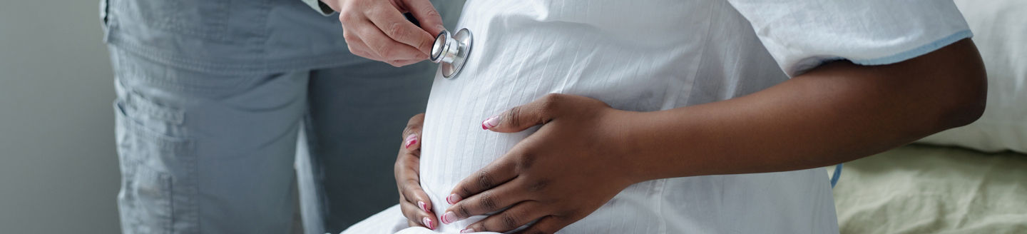 pregnant woman lying bed while doctors checks stomach