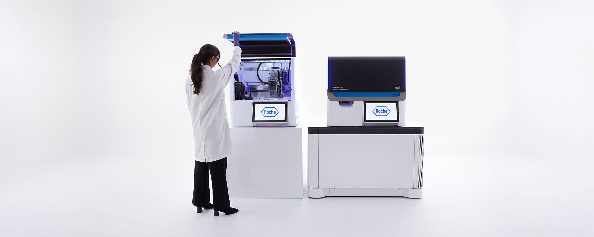 A lab technician opens the AXELIOS 1 next-generation sequencing platform in a bright, modern laboratory