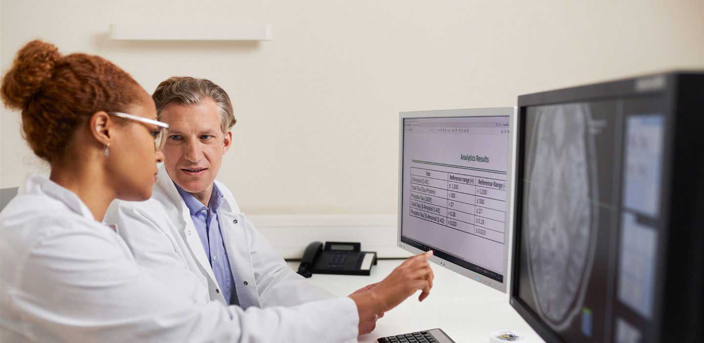 Doctor and lab technicians looking at Alzheimer's Total Tau CSF test results