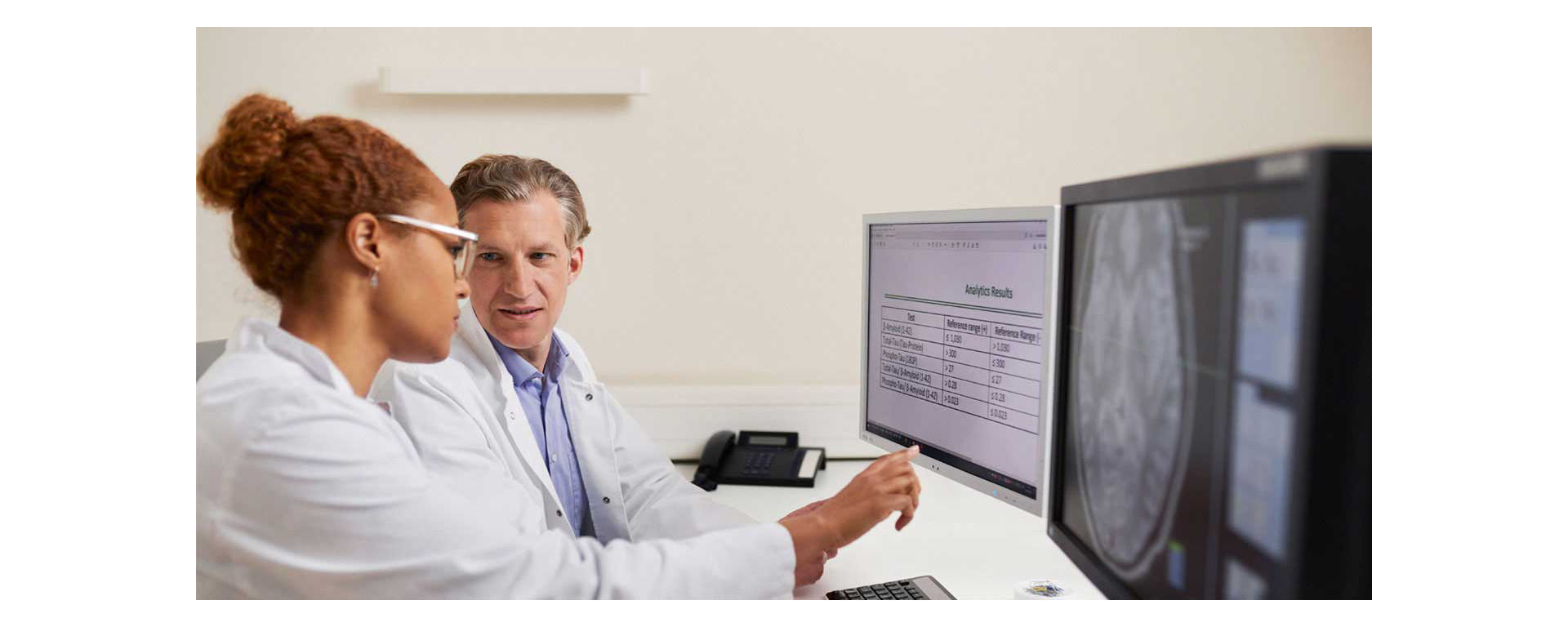Doctor and lab technicians looking at Alzheimer's Total Tau CSF test results