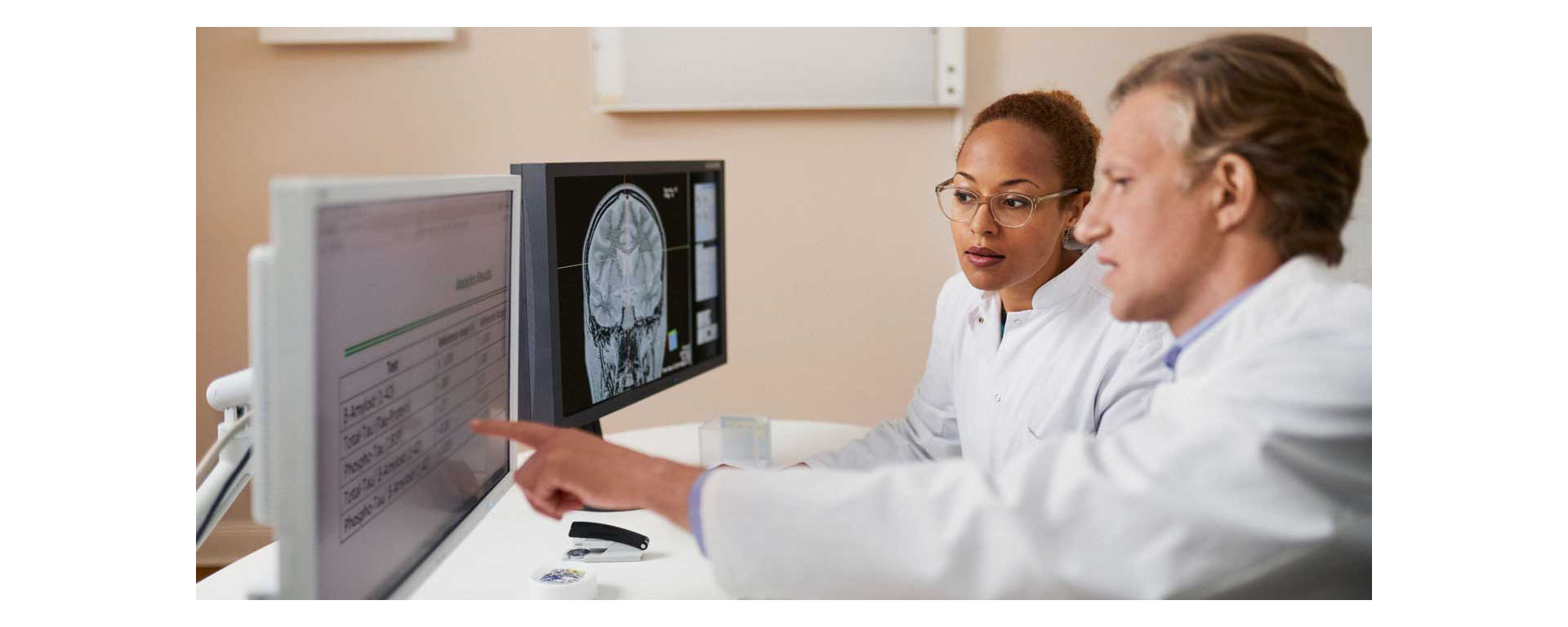 Doctor and lab technician looking at Alzheimer's Disease test results.