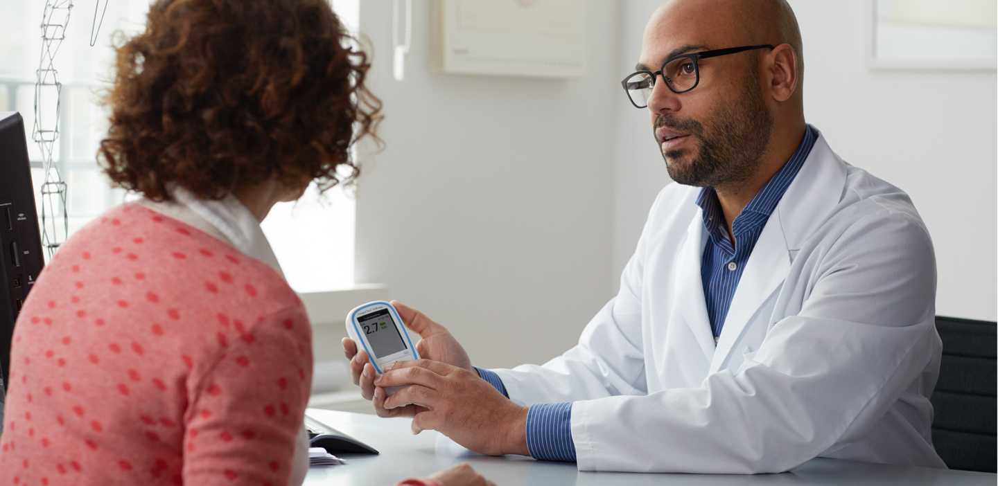 Doctor explaining CoaguChek system to patient