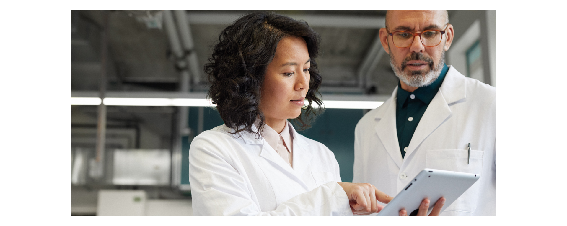 Two lab technicians looking at results for the Elecsys® BRAHMS Procalcitonin (PCT) assay