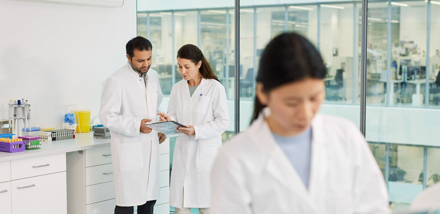 Three people in a laboratory