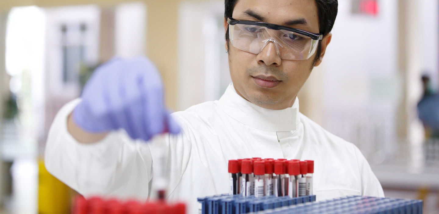 Close up view of person handling blood samples