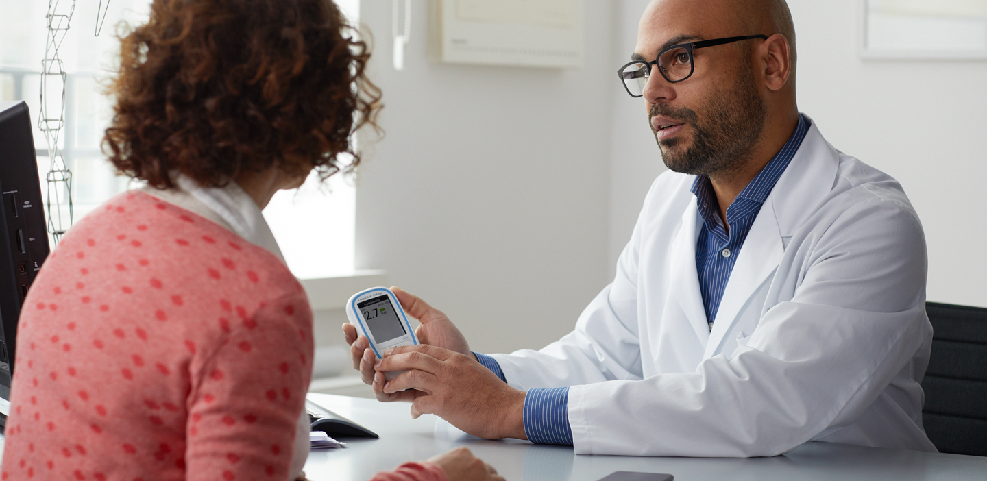 Doctor showing CoaguChek INRange to patient
