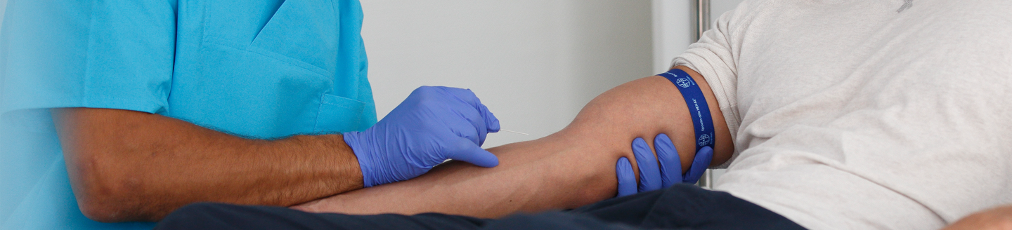 Patient and doctor holding hands during blood transfusion