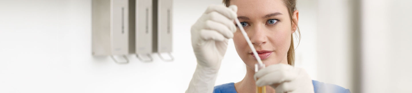 Women analyzing urin test strip