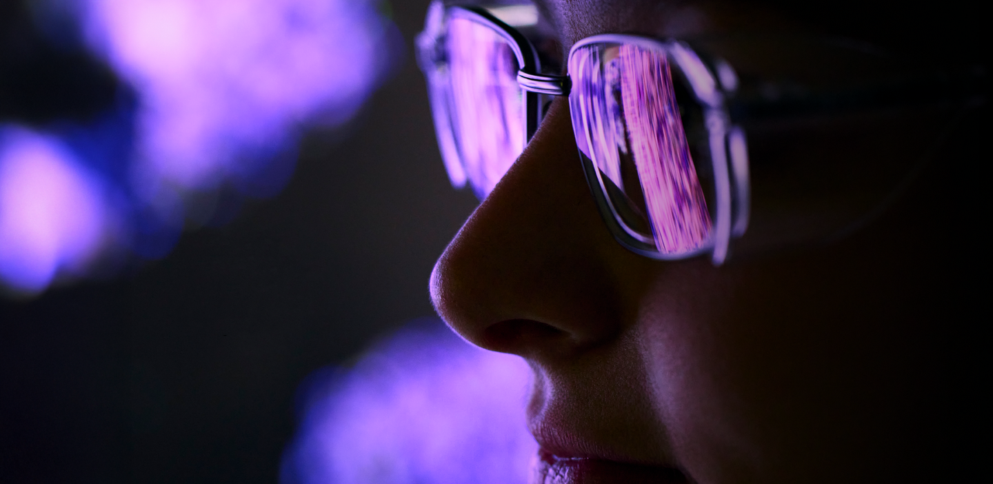 healthcare customer at an event with colored lights reflecting in their glasses