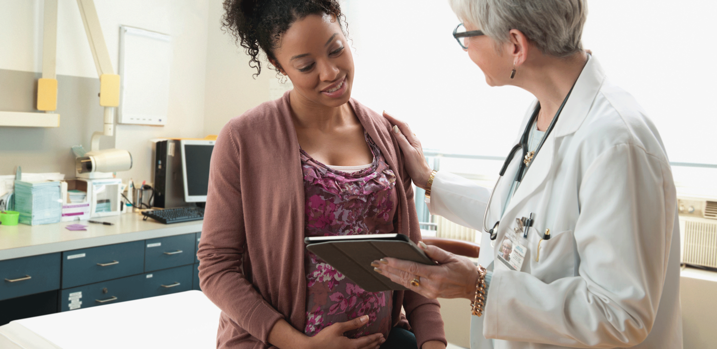 doctor consulting with a pregnant woman