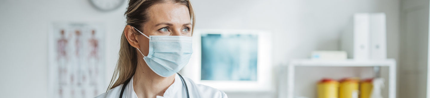 physician wearing mask in clinic
