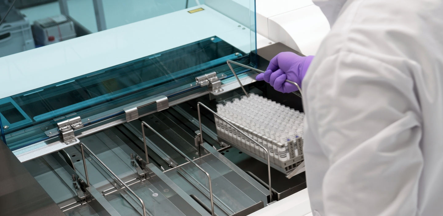 technician loading samples into mass spec i 601 analyzer