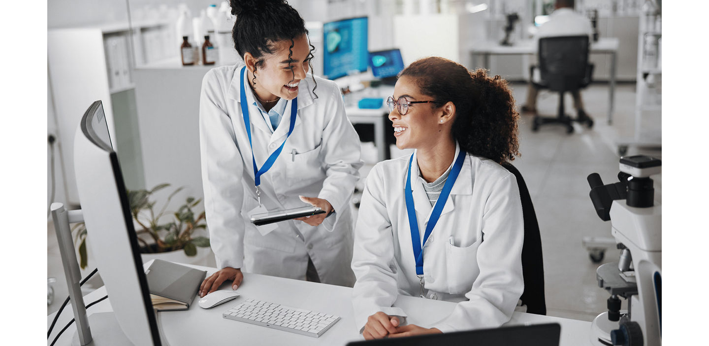 Two lab professionals having a discussion at a workplace in a laboratory.