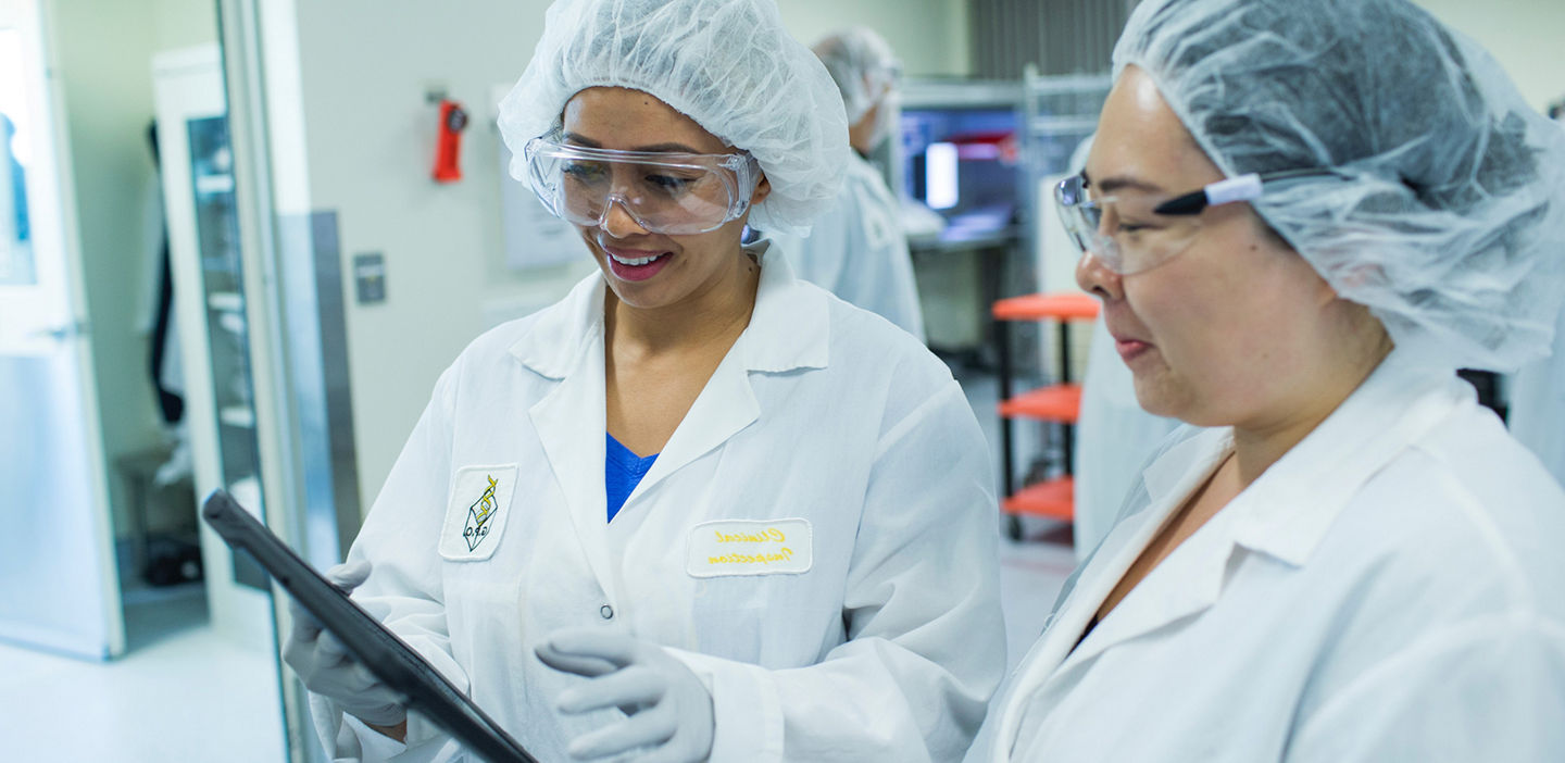 lab professional looking at a sample