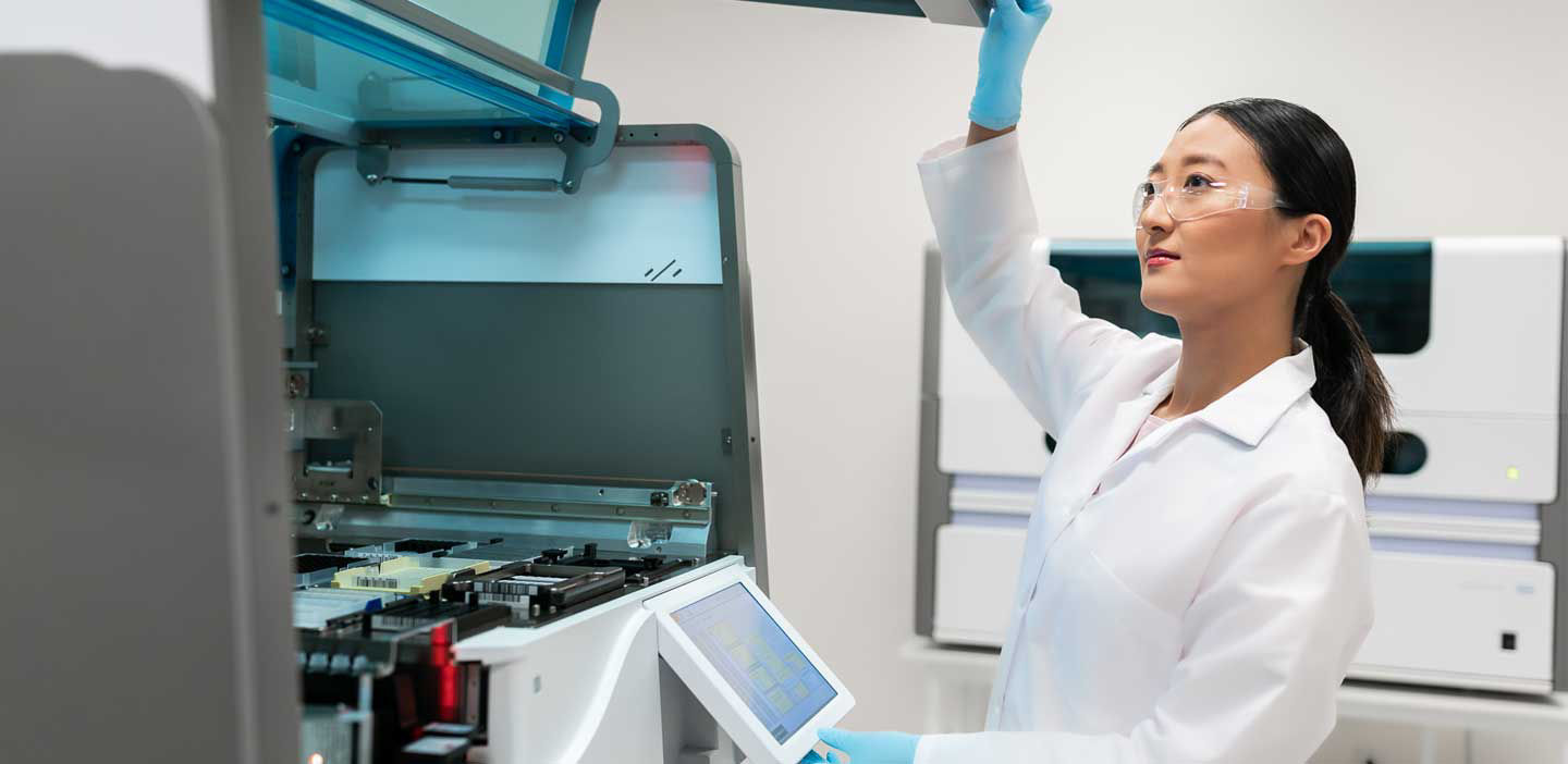 female lab technician with magna pure 96 instrument