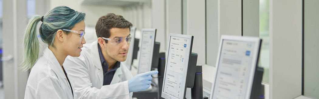 female scientist looking at a desktop screen