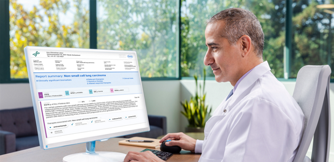 male scientist looking at a desktop screen of navify mutation profiler software