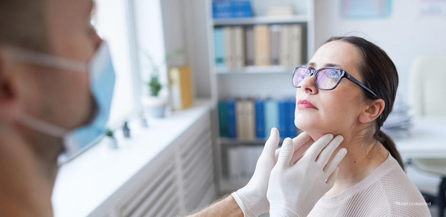A photograph of a healthcare provider examining a patient