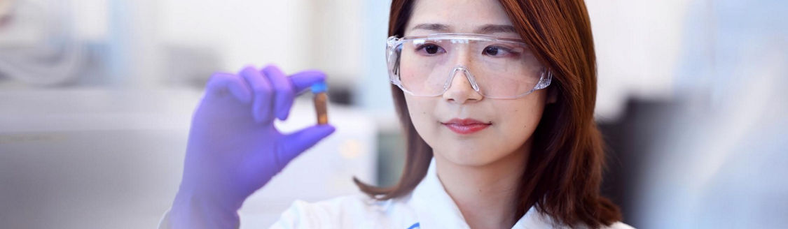 female scientist looking at sample