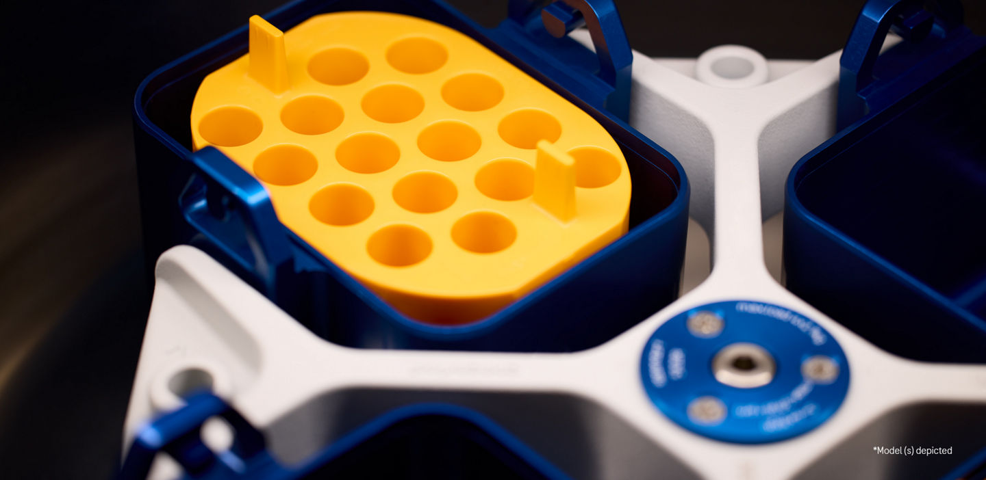 The inside of a diganostic device, a yellow sample tray and blue mechanism for spinning samples.