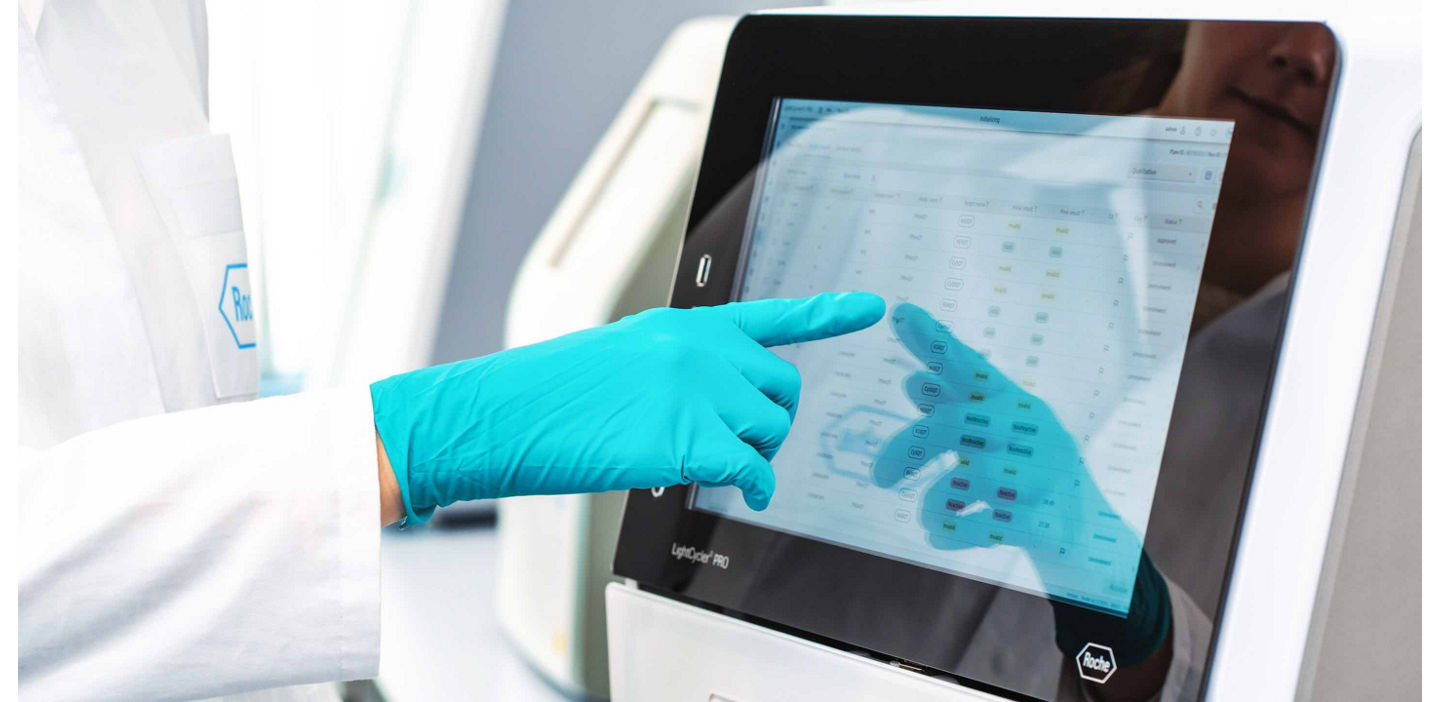 lab technician touching a screen