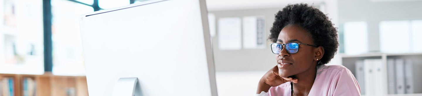 medical doctor looking at desktop computer