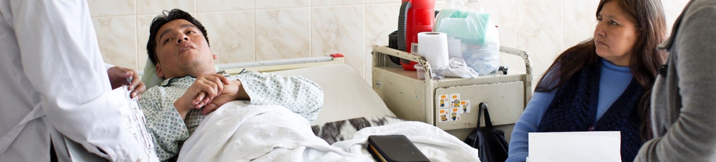 Patient lying in hospital talking to the doctor