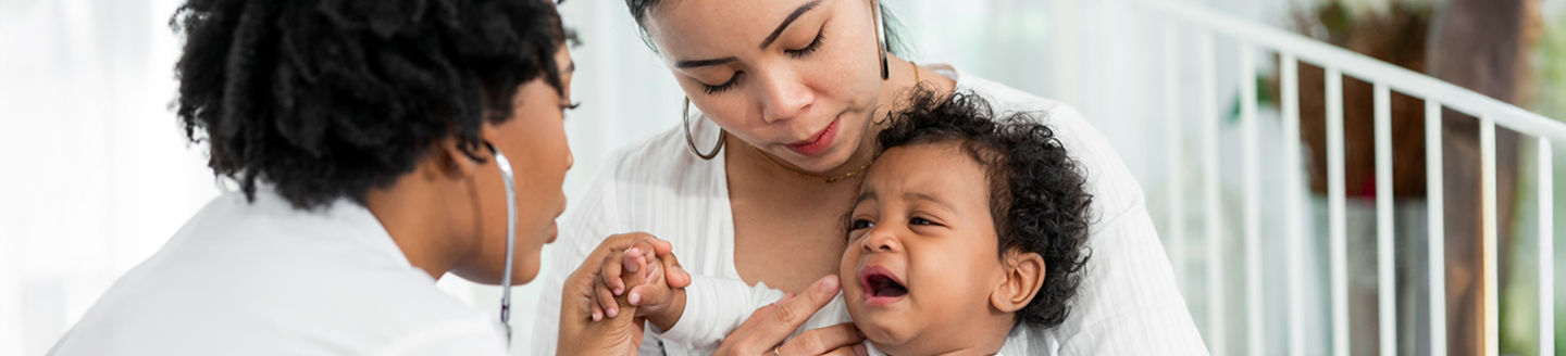 doctors checking child with mother