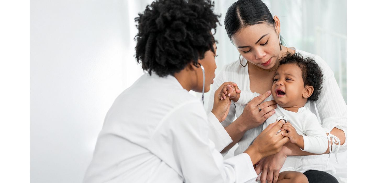 mother and child with physician in clinic