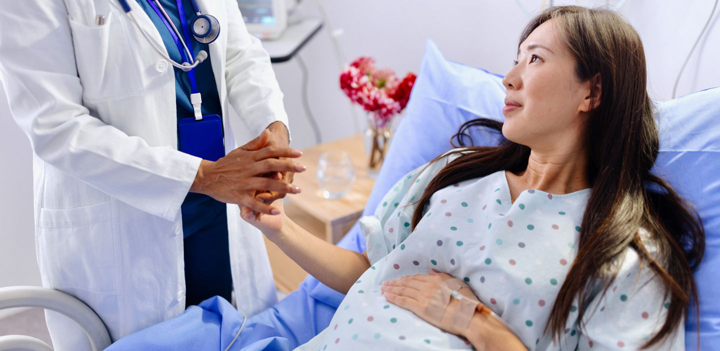 pregnant woman discussing preeclampsia diagnosis with doctor