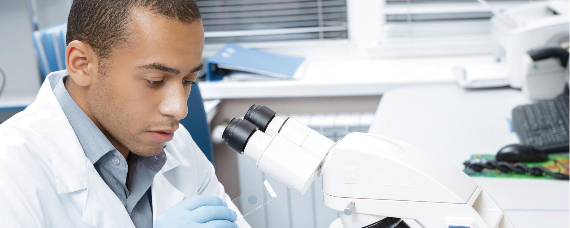 Pathologist in lab - working with microscope